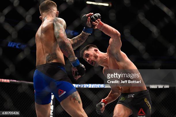 Dominick Cruz punches Cody Garbrandt in their UFC bantamweight championship bout during the UFC 207 event at T-Mobile Arena on December 30, 2016 in...