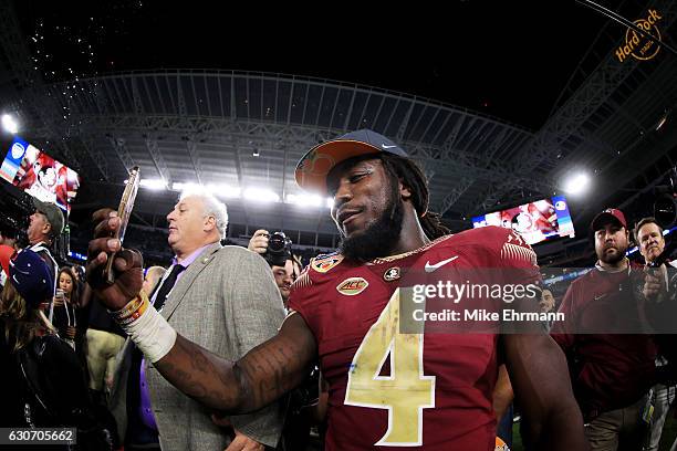 Dalvin Cook of the Florida State Seminoles celebrates their 33 to 32 win over the Michigan Wolverines during the Capitol One Orange Bowl at Sun Life...