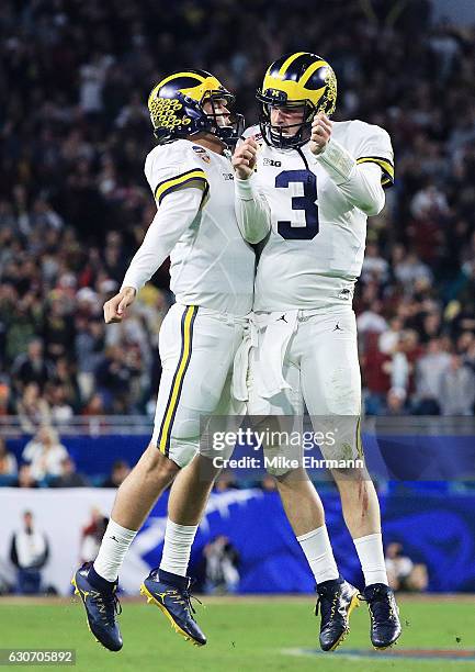 Wilton Speight and John O'Korn of the Michigan Wolverines celebrate after a two-point conversion in the fourth quarter against the Florida State...