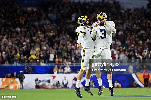 Wilton Speight and John O'Korn of the Michigan Wolverines celebrate after a two-point conversion in the fourth quarter against the Florida State...