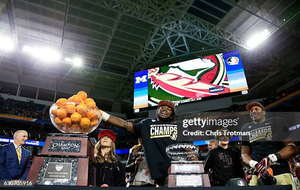 Dalvin Cook of the Florida State Seminoles celebrates their 33 to 32 win over the Michigan Wolverines during the Capitol One Orange Bowl at Sun Life...