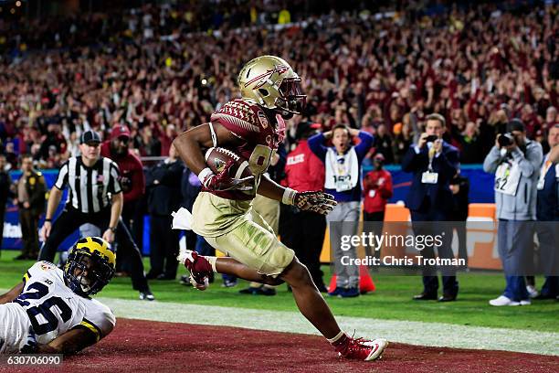 Nyqwan Murray of the Florida State Seminoles scores a touchdown in the fourth quarter against the Michigan Wolverines during the Capitol One Orange...