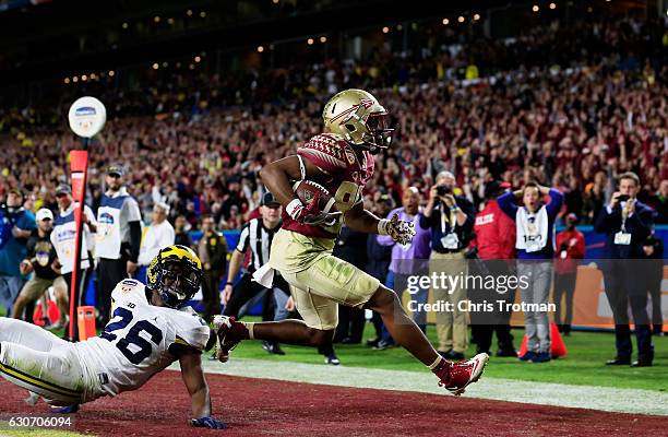 Nyqwan Murray of the Florida State Seminoles scores a touchdown in the fourth quarter against the Michigan Wolverines during the Capitol One Orange...