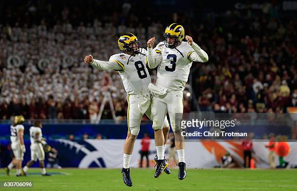 Wilton Speight and John O'Korn of the Michigan Wolverines celebrate after a two-point conversion in the fourth quarter against the Florida State...