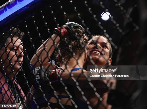 Amanda Nunes of Brazil embraces Ronda Rousey after their UFC women's bantamweight championship bout during the UFC 207 event on December 30, 2016 in...