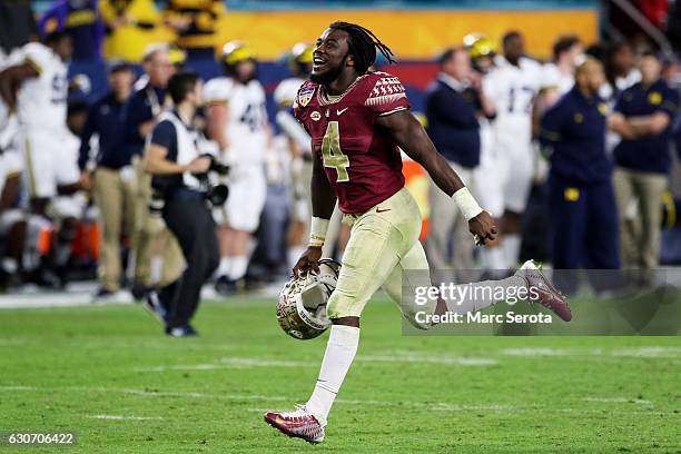 Dalvin Cook of the Florida State Seminoles celebrates their 33 to 32 win over the Michigan Wolverines during the Capitol One Orange Bowl at Sun Life...