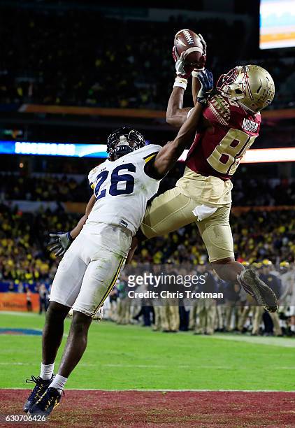 Nyqwan Murray of the Florida State Seminoles scores a touchdown in the fourth quarter against the Michigan Wolverines during the Capitol One Orange...