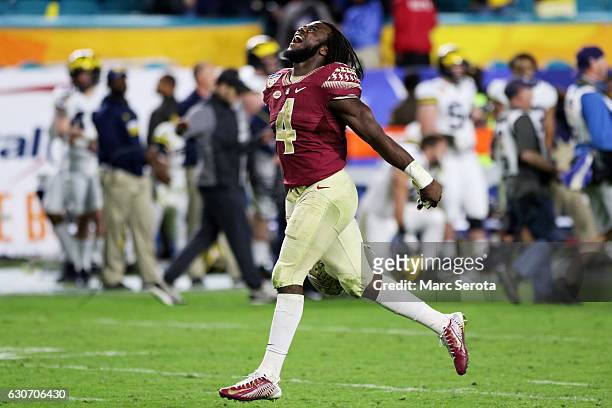 Dalvin Cook of the Florida State Seminoles celebrates their 33 to 32 win over the Michigan Wolverines during the Capitol One Orange Bowl at Sun Life...