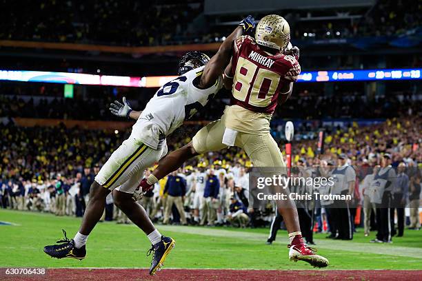 Nyqwan Murray of the Florida State Seminoles scores a touchdown in the fourth quarter against the Michigan Wolverines during the Capitol One Orange...