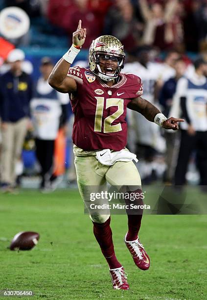 Deondre Francois of the Florida State Seminoles celebrates their 33 to 32 win over the Michigan Wolverines during the Capitol One Orange Bowl at Sun...