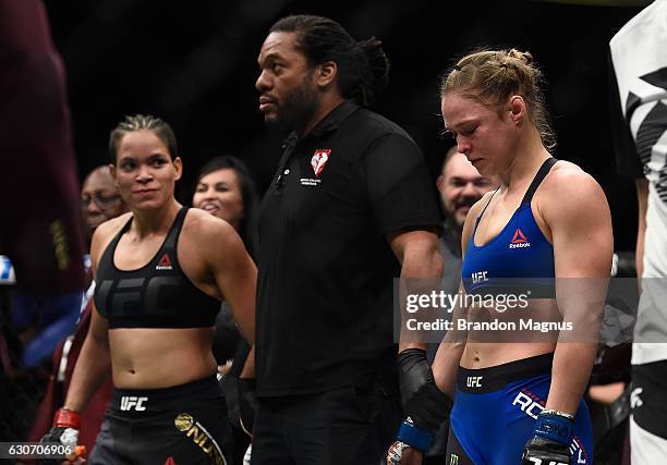 Amanda Nunes of Brazil and Ronda Rousey await the official decision after their UFC bantamweight championship bout during the UFC 207 event at...