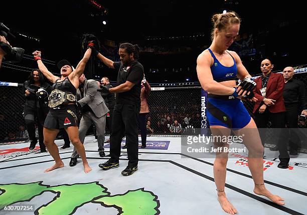 Amanda Nunes of Brazil reacts to her victory over Ronda Rousey in their UFC women's bantamweight championship bout during the UFC 207 event at...
