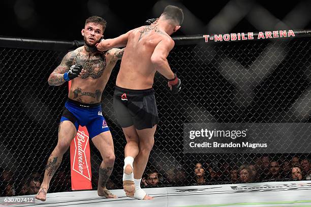 Cody Garbrandt punches Dominick Cruz in their UFC bantamweight championship bout during the UFC 207 event at T-Mobile Arena on December 30, 2016 in...