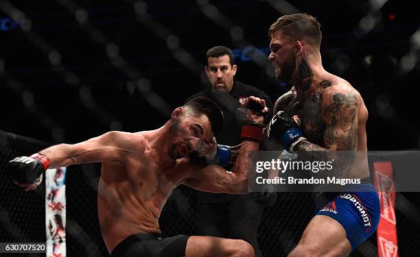 Cody Garbrandt punches Dominick Cruz in their UFC bantamweight championship bout during the UFC 207 event at T-Mobile Arena on December 30, 2016 in...