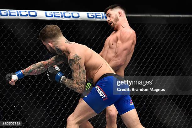 Cody Garbrandt punches Dominick Cruz in their UFC bantamweight championship bout during the UFC 207 event at T-Mobile Arena on December 30, 2016 in...