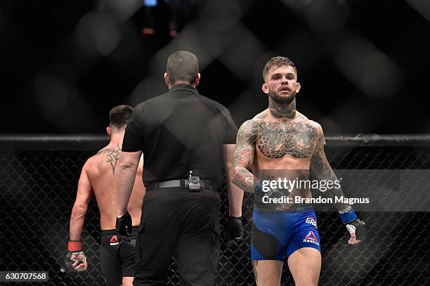 Dominick Cruz and Cody Garbrandt walk back to their corners in their UFC bantamweight championship bout during the UFC 207 event at T-Mobile Arena on...