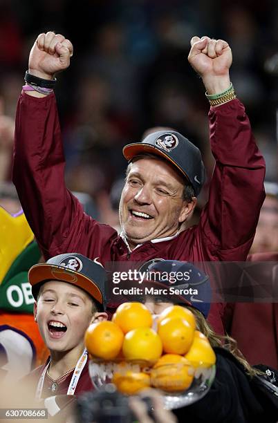 Head coach Jimbo Fisher of the Florida State Seminoles celebrates their 33 to 32 win over the Michigan Wolverines during the Capitol One Orange Bowl...