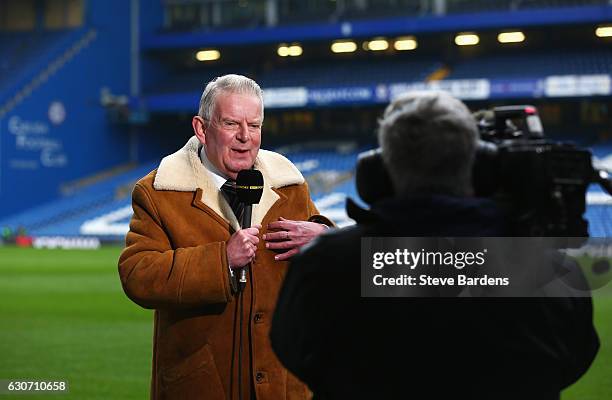 Commentator John Motson speaks prior to the Premier League match between Chelsea and Stoke City at Stamford Bridge on December 31, 2016 in London,...