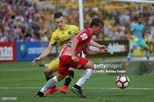 Nick Fitzgerald of Melbourne City is contested by Scott Galloway of the Mariners during the round 13 A-League match between the Central Coast...