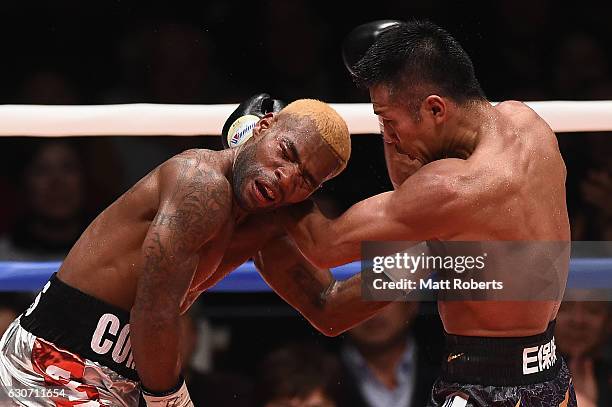 Takashi Uchiyama punches Jezreel Corrales during the WBA Super World Super Featherweight Title bout between Jezreel Corrales of Panama and Takashi...