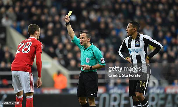 Referee Keith Stroud yellow cards Thomas Lam during the Sky Bet Championship match between Newcastle United and Nottingham Forest at St James' Park...