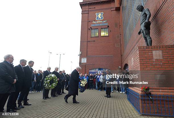 Rangers honorary president John Greig offers a wreath to commemorate the victims of the Ibrox disaster outside the stadium prior to the Ladbrokes...