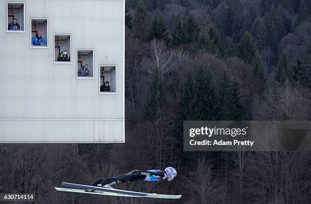Judges look to Andreas Wellinger of Germany during his qualification jump on Day 1 of the 65th Four Hills Tournament ski jumping event on December...