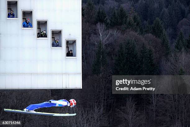 Judges look to an athlet during a qualification jump on Day 1 of the 65th Four Hills Tournament ski jumping event on December 31, 2016 in...