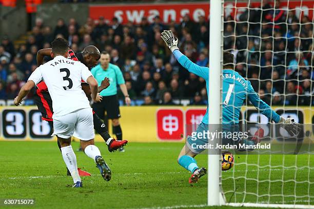 Benik Afobe of AFC Bournemouth scores the opening goal past Lukasz Fabianski of Swansea City during the Premier League match between Swansea City and...