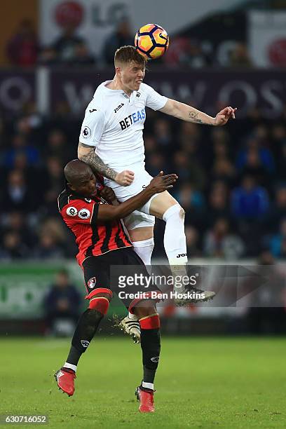 Alfie Mawson of Swansea City and Benik Afobe of AFC Bournemouth compete for the ball during the Premier League match between Swansea City and AFC...