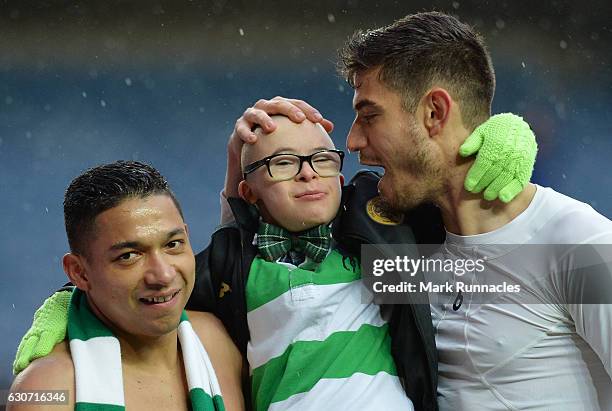 Celtic Foundation charity ambassador and fan Jay Beatty celebrates victory with Emilio Izaguirre and Nir Bitton after the Ladbrokes Scottish...