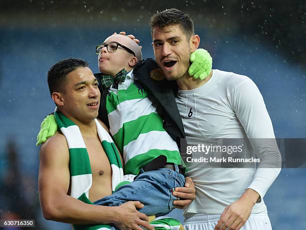 Celtic Foundation charity ambassador and fan Jay Beatty celebrates victory with Emilio Izaguirre and Nir Bitton after the Ladbrokes Scottish...