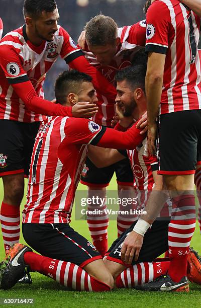 Shane Long of Southampton celebrates scoring the opening goal with his team mates including Dusan Tadic during the Premier League match between...