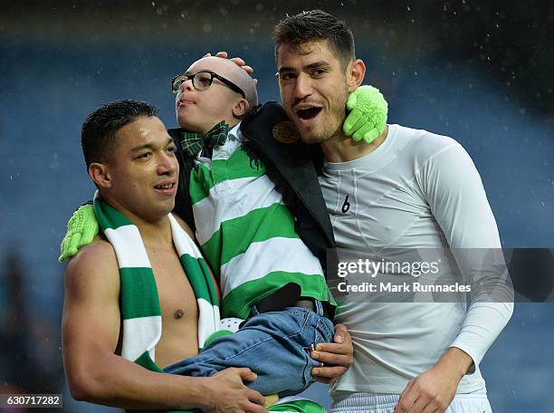 Emilio Izaguirre , and Nir Bitton of Celtic celebrate at the final Whistle with a young fan during the Scottish Premiership match between Rangers FC...