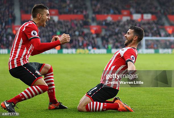 Shane Long of Southampton cekebrates scoring the opening goal with his team mate Dusan Tadic during the Premier League match between Southampton and...