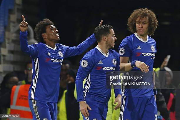 Chelsea's Brazilian midfielder Willian celebrates with teammates after scoring their second goal during the English Premier League football match...
