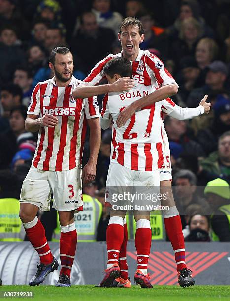 Peter Crouch of Stoke City celebrates scoring his team's second goal with his team mates Bojan Krkic and Erik Pieters during the Premier League match...