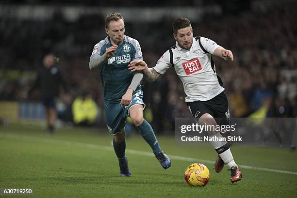 Derby, ENGLANDJacob Butterfield of Derby County and Andy Kellett of Wigan Athletic in action during the Sky Bet Championship match between Derby...