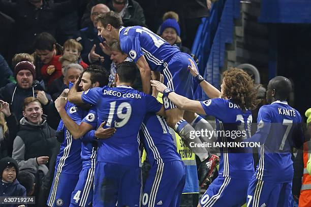 Chelsea's Brazilian midfielder Willian celebrates with teammates after scoring their third goal during the English Premier League football match...