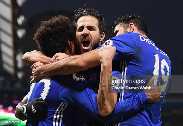 Willian of Chelsea celebrates scoring his team's third goal with his team mates Cesc Fabregas and Diego Costa during the Premier League match between...