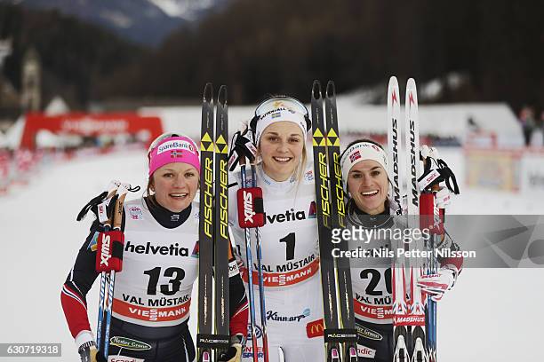 Maiken Caspersen Falla of Norway, Stina Nilsson of Sweden and Heidi Weng of Norway celebrates during the women's Sprint F race on December 31, 2016...