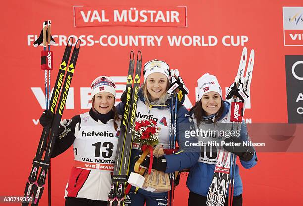 Maiken Caspersen Falla of Norway, Stina Nilsson of Sweden and Heidi Weng of Norway celebrates during the women's Sprint F race on December 31, 2016...