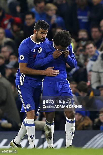Chelsea's Brazilian midfielder Willian is consoled by Chelsea's Brazilian-born Spanish striker Diego Costa as he reacts after scoring a goal during...