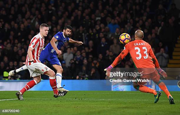 Diego Costa of Chelsea scores his side's fourth goal past Lee Grant of Stoke City during the Premier League match between Chelsea and Stoke City at...