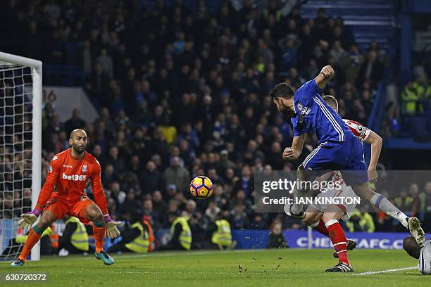 Chelsea's Brazilian-born Spanish striker Diego Costa shoots past Stoke City's English goalkeeper Lee Grant to score their fourth goal during the...