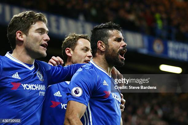 Diego Costa of Chelsea celebrates scoring his team's fourth goal with his team mates during the Premier League match between Chelsea and Stoke City...