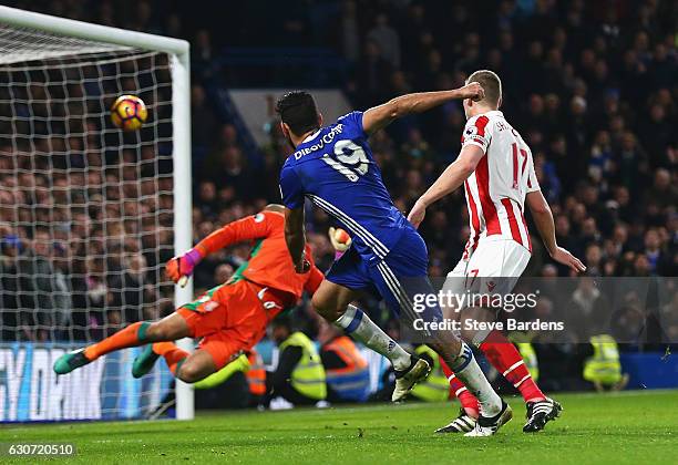 Diego Costa of Chelsea scores his side's fourth goal past Lee Grant of Stoke City during the Premier League match between Chelsea and Stoke City at...