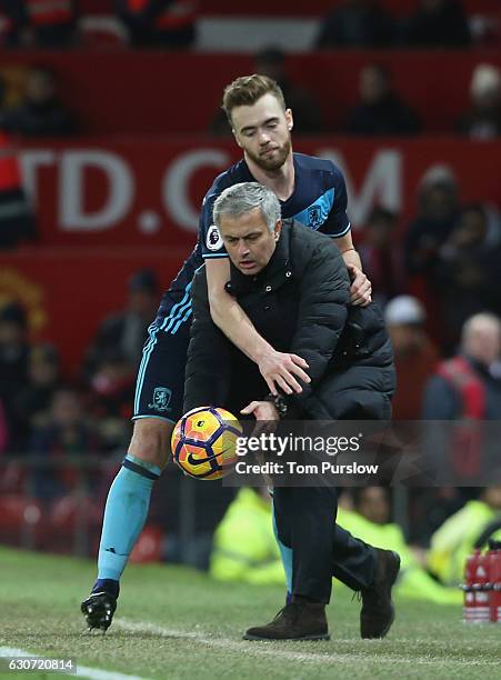 Manager Jose Mourinho of Manchester United tussles with Calum Chambers of Middlesbrough during the Premier League match between Manchester United and...