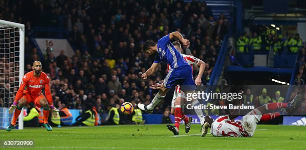 Diego Costa of Chelsea scores his side's fourth goal past Lee Grant of Stoke City during the Premier League match between Chelsea and Stoke City at...