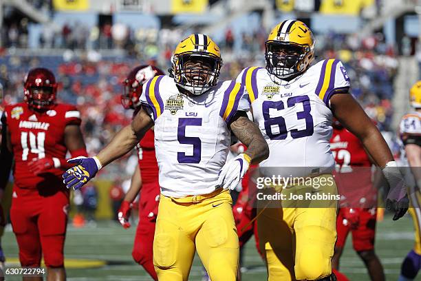 Derrius Guice of the LSU Tigers celebrates after rushing for a first down against the Louisville Cardinals in the first quarter of the Buffalo Wild...